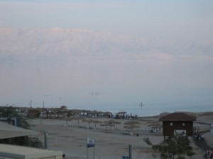 The Dead Sea bathing area with the hazy mountains of Jordan on the other side. The River Jordan and Dead Sea are the border.