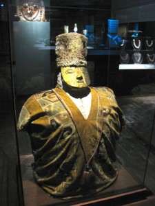 A burial bundle - the person was folded into the fetal position and wrapped in layers of cloth which also included funerary offerings. The bundle was finally dressed including a gold death mask.