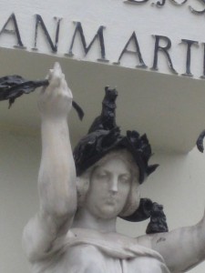 When the commission for the statue was given they misstaken "llama" for the animal instead of flames. So she ended up with a llama on her head!